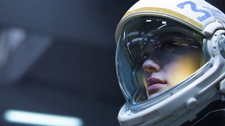 A woman in a space helmet stares at something off the screen in Arc Raiders