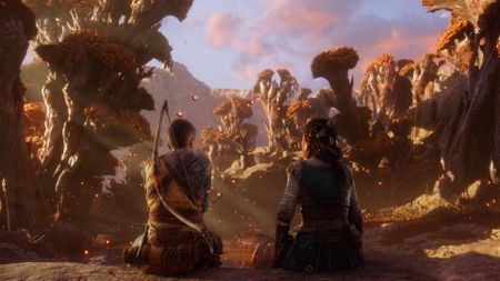 Atreus and Angrboda sit next to one another in a forest in God of War Ragnarok